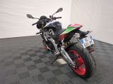 a motorcycle that is parked on a black and white checkered floor