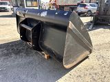 an image of a black skid steer on the ground