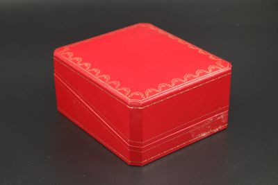 a small red box on a table with a black background