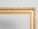 an image of a gold framed mirror against a white wall