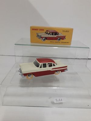 two toy cars are on display in a glass case