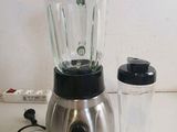 a blender that is sitting on a counter next to a cup