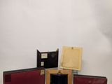 three open books sitting on top of a table next to a white wall