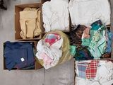 a box full of clothes that is sitting on the floor