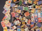 a pile of stamps on a table with a black background
