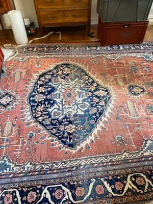 a large oriental rug on the floor in a living room