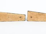 two pieces of wood are sitting next to each other on a white surface