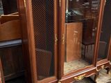 a cabinet that has a glass door on top of it
