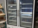 two refrigerators that are sitting in a room