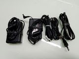 three power cords and a charger sitting on a table