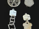 several different types of charms on a black surface