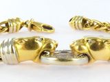 a close up of a gold bracelet with two elephants on it