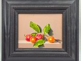 une photo d'un tableau représentant des cerises, dans un cadre noir