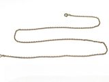 an image of a chain that is laying on top of a white surface