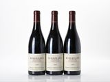 trois bouteilles de vin rouge posées côte à côte sur une table