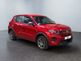 a red suv parked in a room with a white wall