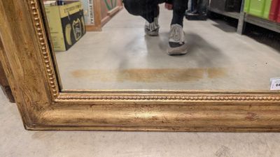 a reflection of a person in a mirror on the floor