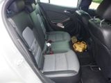 the back seat of a car with a bunch of items in it
