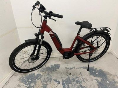 a red bike that is parked in a room