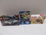 three lego cars are sitting next to each other on a table