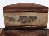 a wooden box with a carved design on top of it