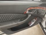 the interior of a car with the door open and the driver ' s seat up