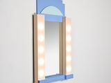 mirror with light bulbs on the sides of it and a mirror on the back of it