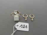 two rings and a pair of earrings are on a table