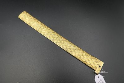 a close up of a knife on a table with a tag on it