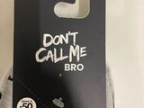 someone is holding a pair of socks that say don ' t call me bro