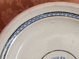 a blue and white plate with a blue border on it