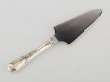 a silver knife with a black handle on a white surface