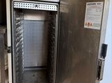 a small oven that is open in a room