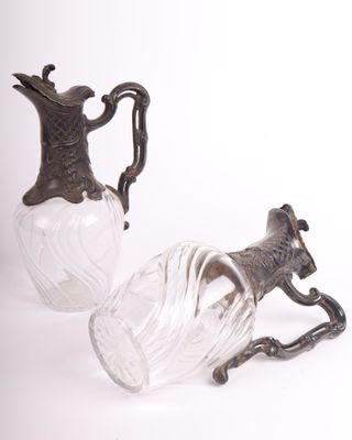 two glass vases with a horse on them on a white surface