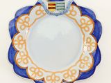 a blue and white plate with a crown on it