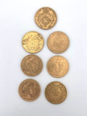 a group of five different coins sitting on top of a white surface
