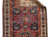 a red and blue rug on a white background