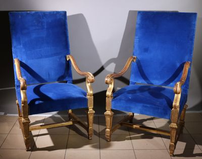 pair of blue velvet upholstered chairs in a room