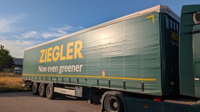a green semi truck that is parked on the side of the road