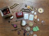a wooden table with a box of jewelry on it