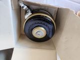 a box with a black and gold wheel inside of it