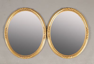 une paire de miroirs ovales à cadre doré