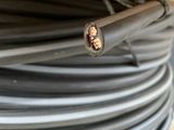 a close up of a wire with a piece of electrical wire in it