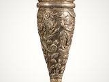 an image of a silver vase with a bird on it