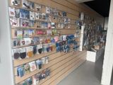 a wall full of various items on display in a store