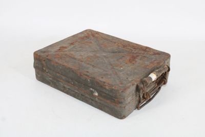 an old metal box that is sitting on a white surface
