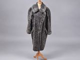 a grey and black fur coat on a mannequin mannequin stand