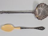 two spoons and a spoon with a spoon rest on a table