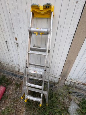 a ladder leaning against a wall next to a fire hydrant