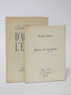 an old book sitting on top of a table next to another book